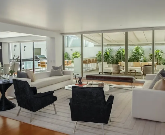 Modern spacious living room with natural light and furniture.