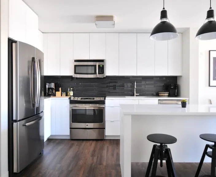 Modern kitchen with stainless steel appliances and breakfast bar.