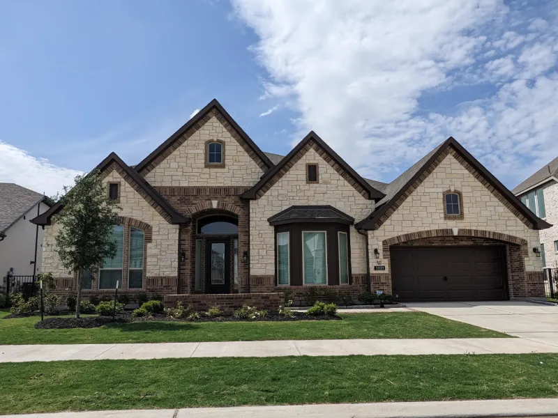 New suburban single-family home with stone facade.