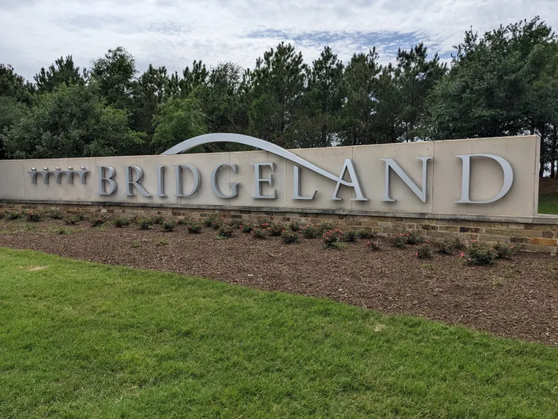 Bridgeland community sign with landscaped flowerbed.