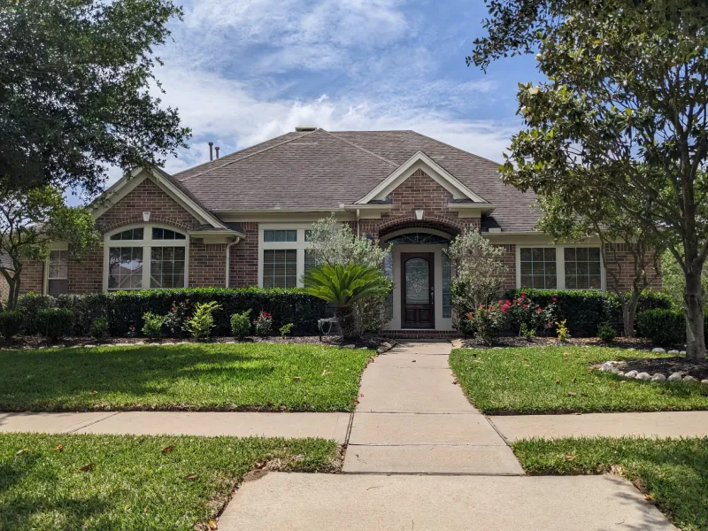 Suburban single-family house with landscaped front yard.