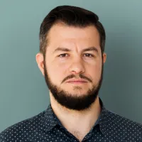 Man with beard in patterned shirt.